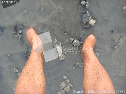 Image of Legs of the person standing in a dirt