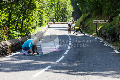 Image of Woman Painting the Road to Col d'Aubisque