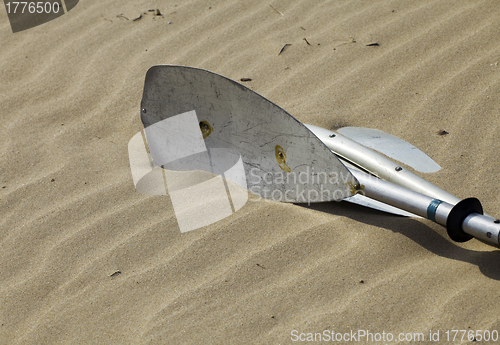 Image of Kayak paddles laying in the sand