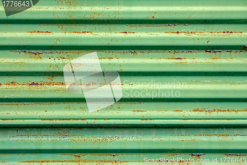 Image of Rusty metal surface painted in green