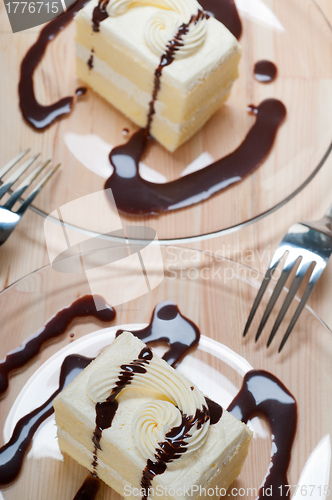 Image of fresh cream cake closeup with chocolate sauce
