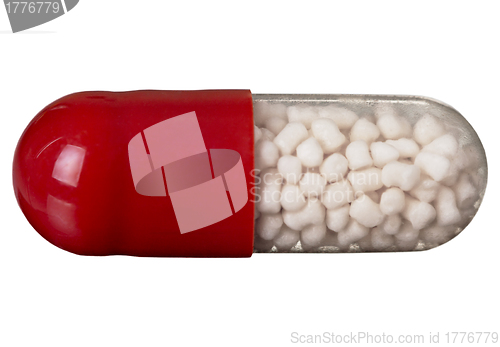 Image of One red pill isolated on white