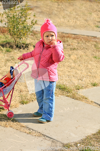 Image of Little girl with pram