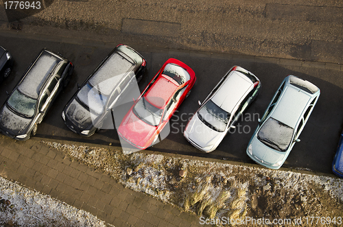 Image of Cars covered snow stand in parking in winter 