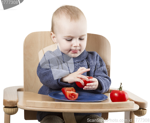 Image of young child eating in high chair
