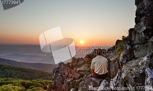 Image of Senior man watches sunrise over blue ridge