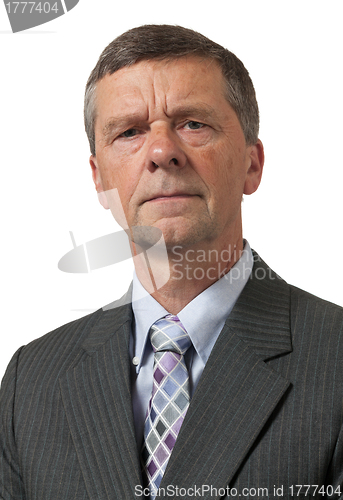 Image of Senior man in blue shirt looks pensive