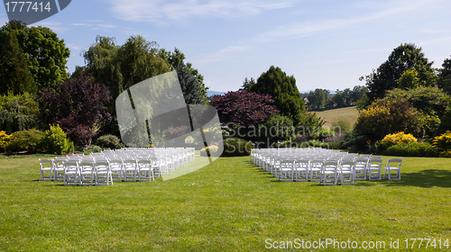 Image of Rows of wooden chairs set up for wedding