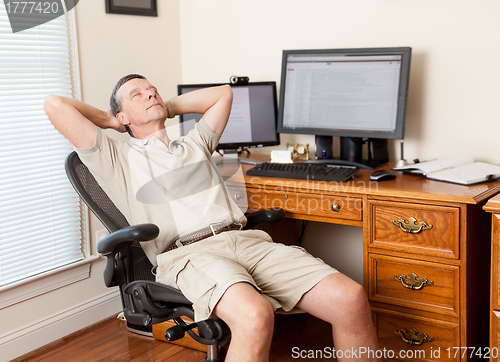 Image of Senior male working in home office