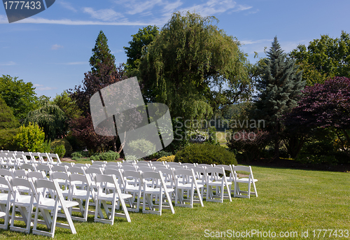 Image of Rows of wooden chairs set up for wedding