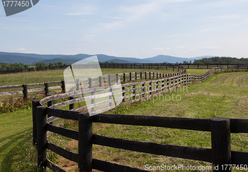 Image of Rolling meadows with wooden fences and hills