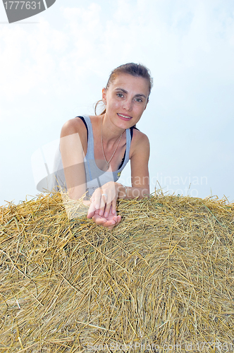 Image of The woman on a haystack.