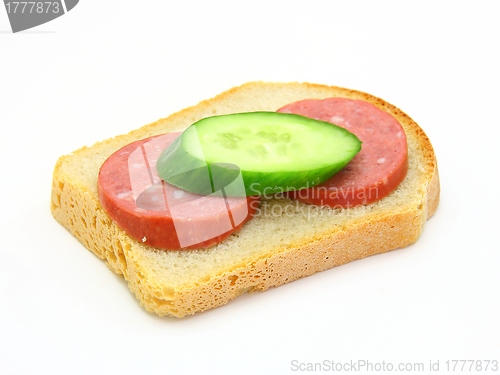 Image of  sandwich with sausage and a cucumber 