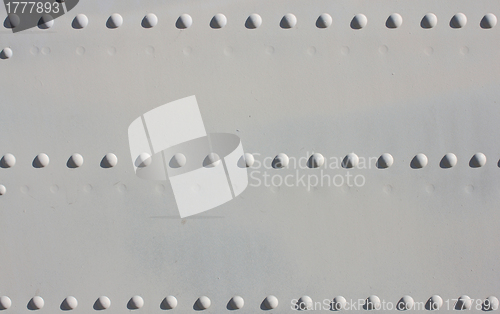 Image of A silver painted metal aircraft background  with  rivets.