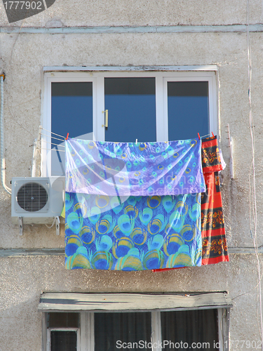 Image of The clothes dry at a white window 