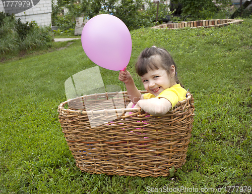 Image of Baby girl in the basket with the ball