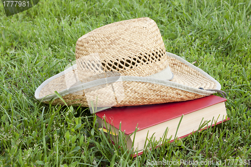 Image of Straw hat with a book