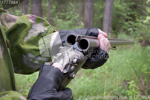 Image of Hunter examines the old gun