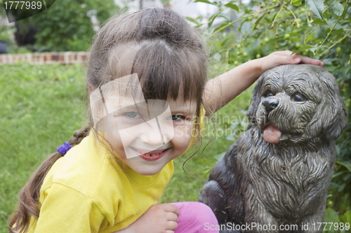 Image of Girlie  near to concrete dog