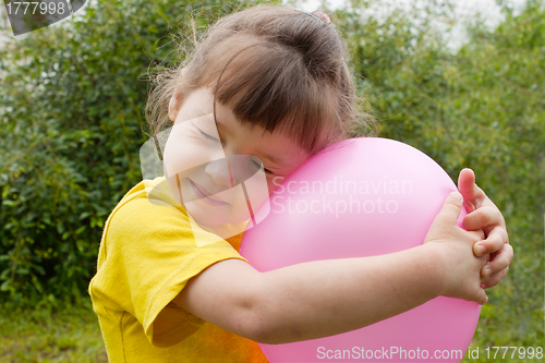 Image of Baby girl and inflatable ball