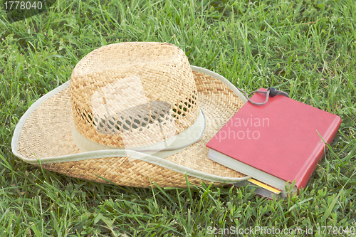 Image of Straw hat with a book