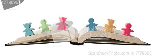 Image of Figurines on open book