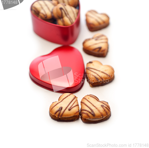 Image of heart shaped cream cookies on red heart metal box