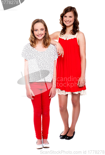 Image of Two young girls posing. Full length shot