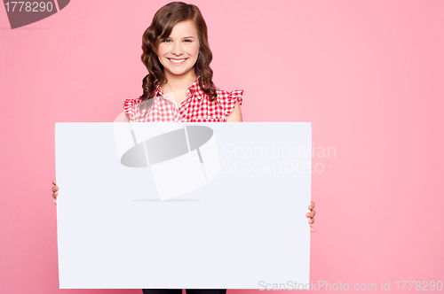 Image of Beautiful girl holding blank billboard