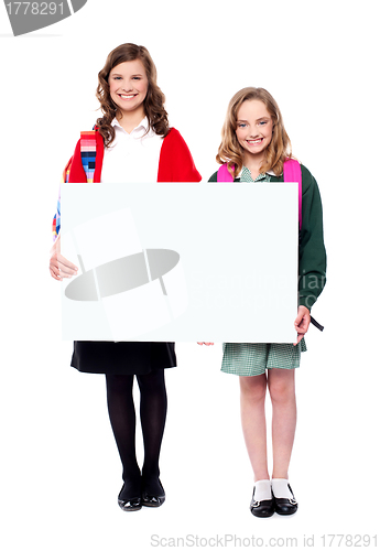 Image of Schoolgirls holding big blank banner ad