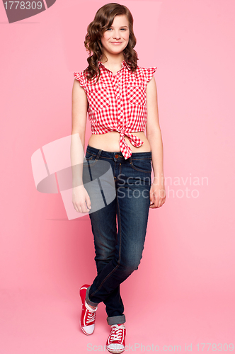 Image of Pretty teenager standing with crossed legs