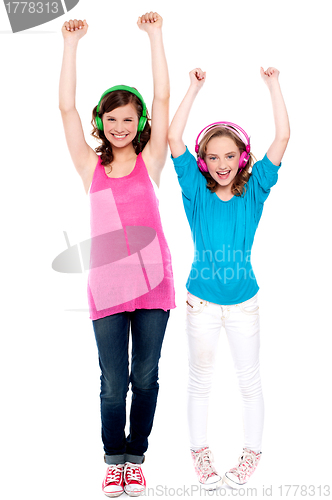 Image of Excited young girls enjoying music together