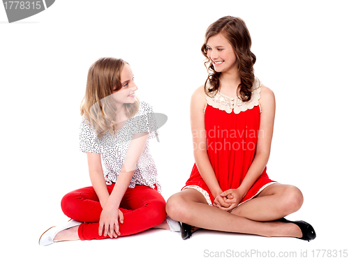 Image of Young cheerful girls sitting together