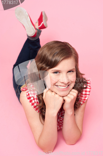 Image of Beautiful girl posing with hands on chin