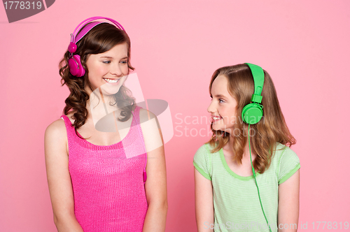 Image of Two teenage friends enjoying music together