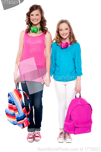 Image of Best friends standing hand in hand and smiling