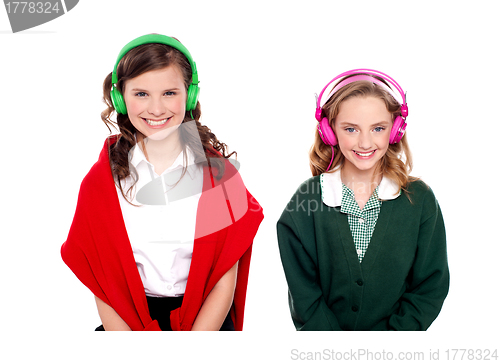 Image of Schoolgirls listening music through headphones