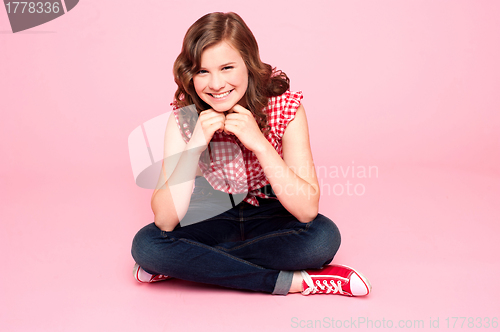 Image of Caucasian girl sitting with hands on chin