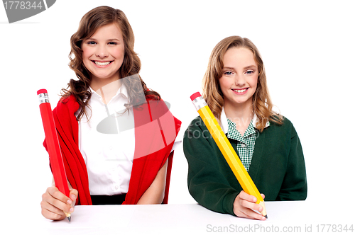 Image of Female students writing with big pencil