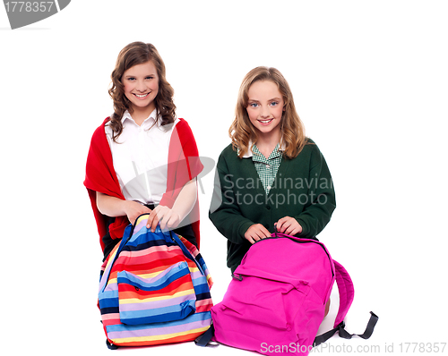 Image of Pretty girls unzipping school bag