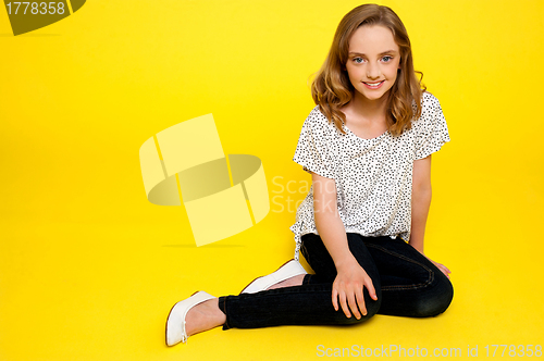 Image of Trendy young fashionable girl sitting in style