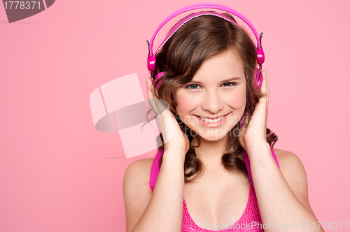 Image of Pretty caucasian girl tuned into music