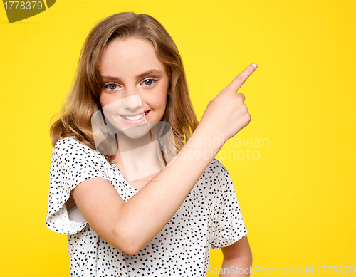 Image of Smiling caucasian girl indicating upwards