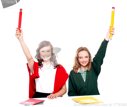 Image of Students showing big pencil in raised arm