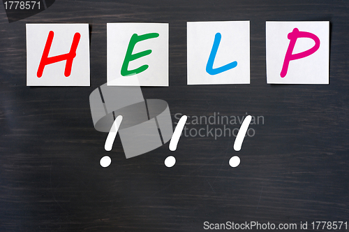 Image of Help written on sticky notes on a blackboard background