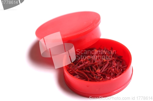 Image of saffron threads in a red beverage