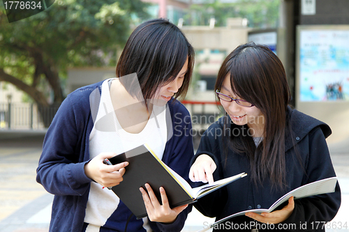 Image of Asian students studying and discussing in university