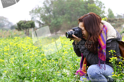 Image of Female photographer on field
