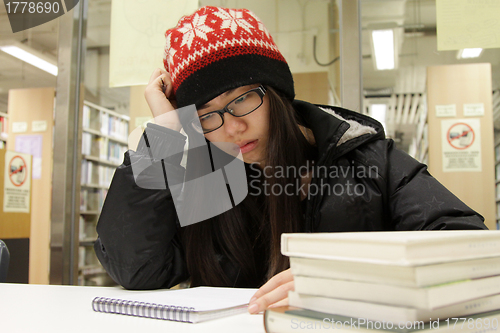 Image of Asian woman studying in library
