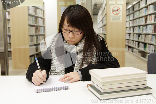 Image of Asian woman studying in library